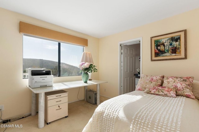 bedroom featuring light colored carpet and a mountain view