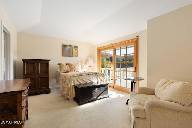 bedroom with light carpet, lofted ceiling, and access to outside