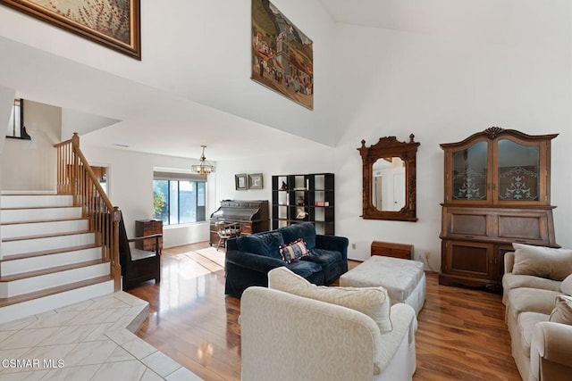 living room featuring a chandelier and light hardwood / wood-style floors