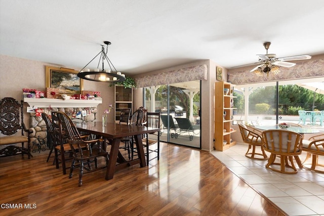 tiled dining space featuring ceiling fan