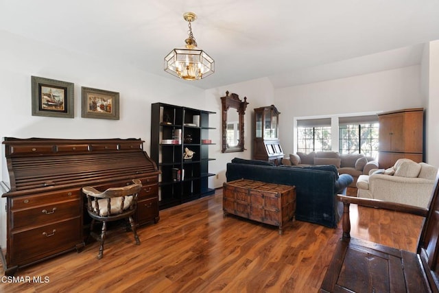 living room with dark hardwood / wood-style floors and a notable chandelier