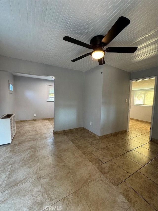 spare room featuring ceiling fan and a healthy amount of sunlight