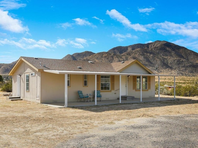 view of front of home featuring a mountain view and a patio