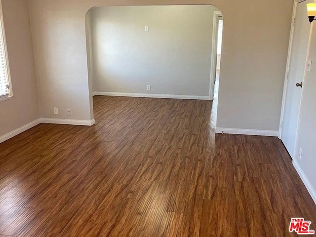 unfurnished room featuring dark hardwood / wood-style floors