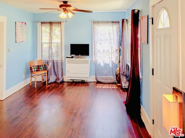 interior space with ceiling fan and dark wood-type flooring