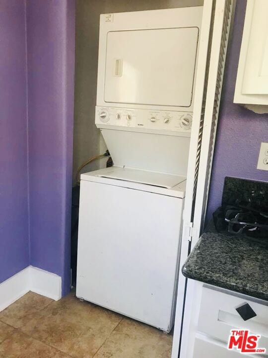 washroom with stacked washer and dryer