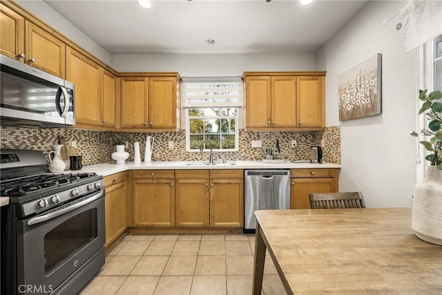 kitchen featuring sink, light tile patterned floors, stainless steel appliances, and tasteful backsplash