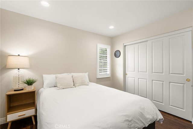 bedroom featuring dark wood-type flooring and a closet