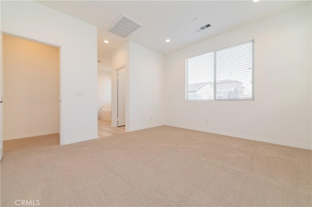 unfurnished room with light colored carpet