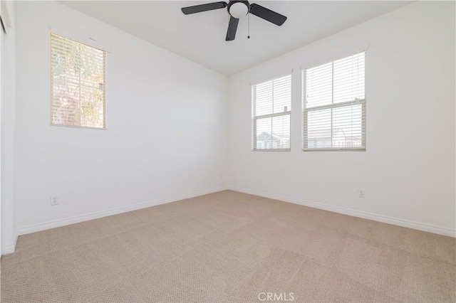 empty room with ceiling fan and light colored carpet