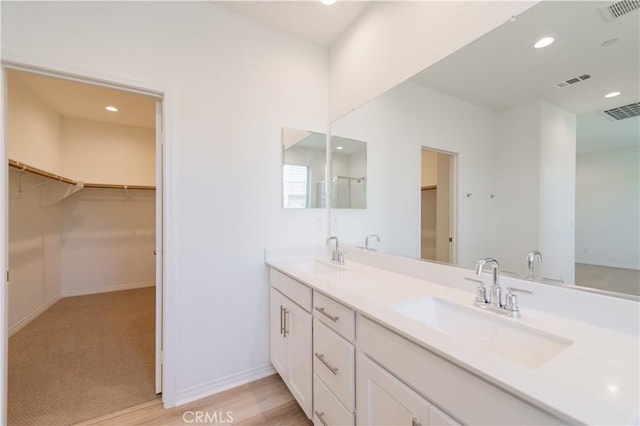 bathroom with hardwood / wood-style floors and vanity