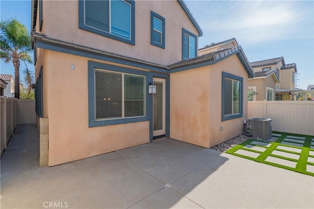 rear view of house featuring central AC and a patio area