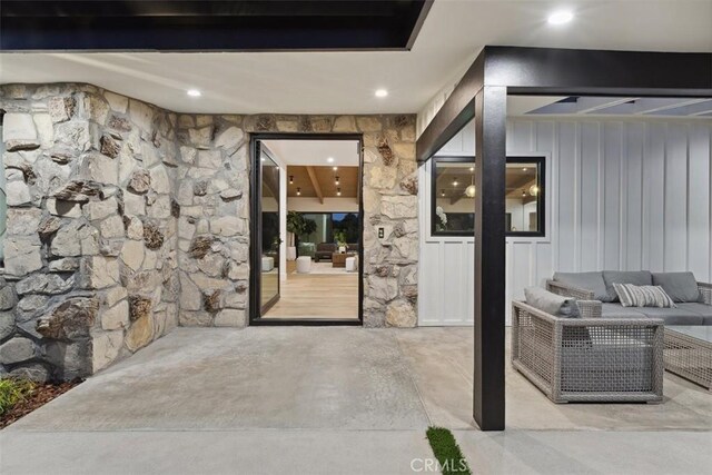 property entrance featuring outdoor lounge area and a patio