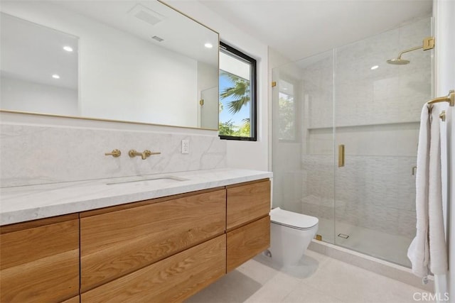 bathroom with tile patterned flooring, a shower with door, vanity, backsplash, and toilet