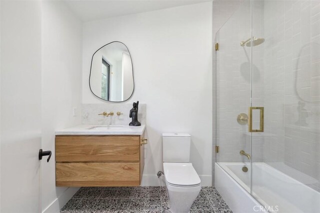 full bathroom with toilet, vanity, and combined bath / shower with glass door