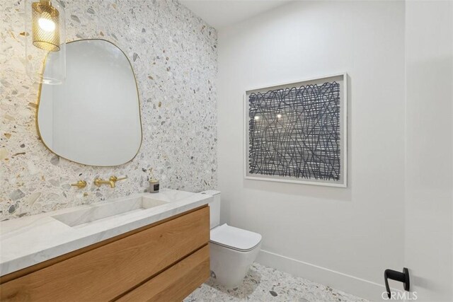 bathroom featuring toilet and vanity