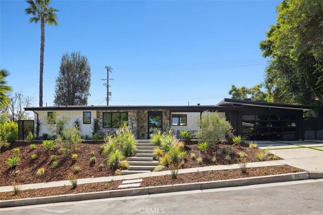 view of front of property featuring a carport