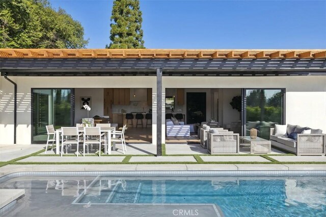 rear view of house with an outdoor living space and a patio