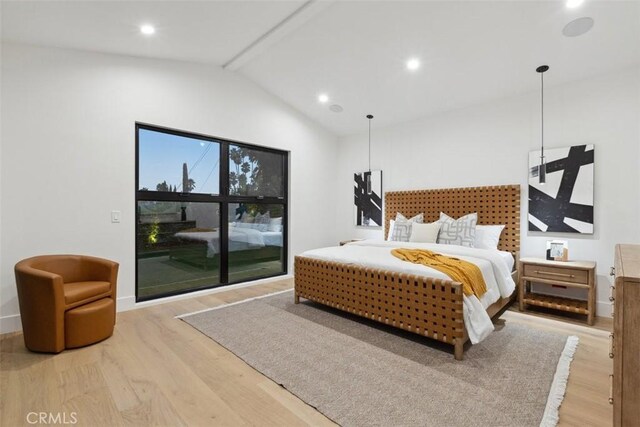 bedroom with lofted ceiling and hardwood / wood-style floors