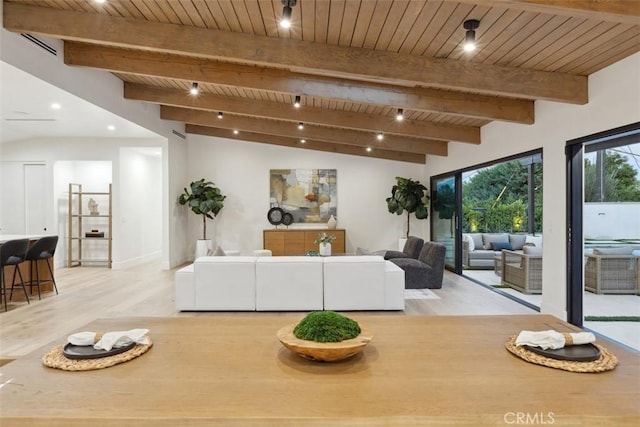 interior space featuring wooden ceiling, light hardwood / wood-style flooring, and vaulted ceiling with beams