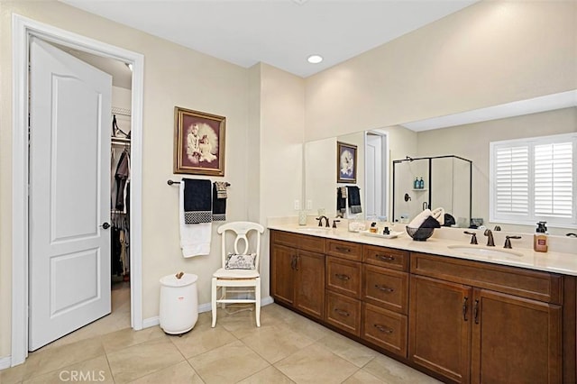 bathroom featuring walk in shower, tile patterned floors, and vanity