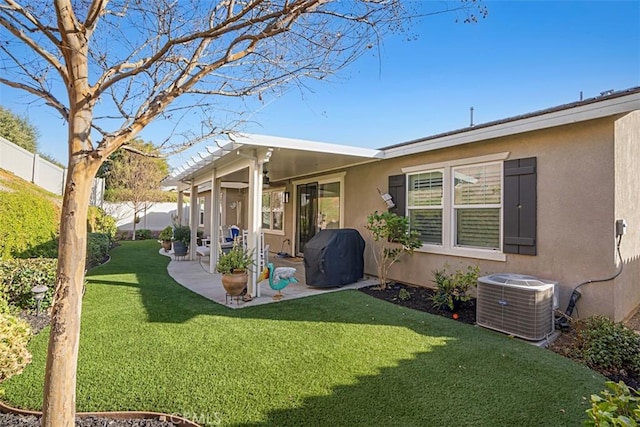 back of property with a lawn, a patio area, and central air condition unit