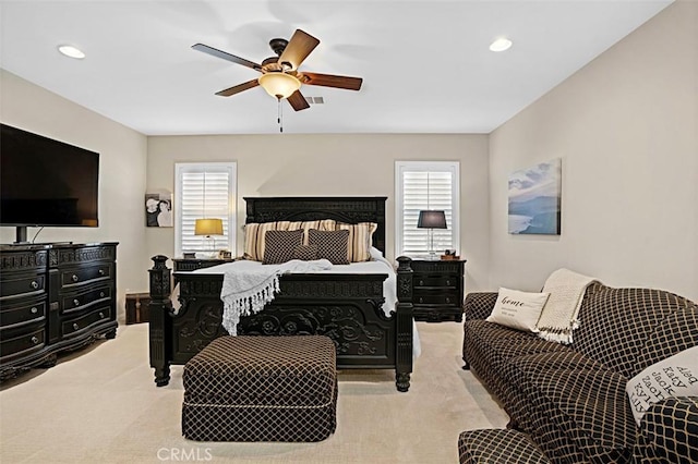 bedroom with light colored carpet and ceiling fan