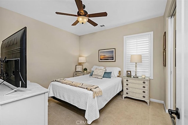 bedroom featuring ceiling fan and light carpet