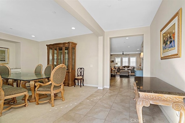 tiled dining room featuring ceiling fan