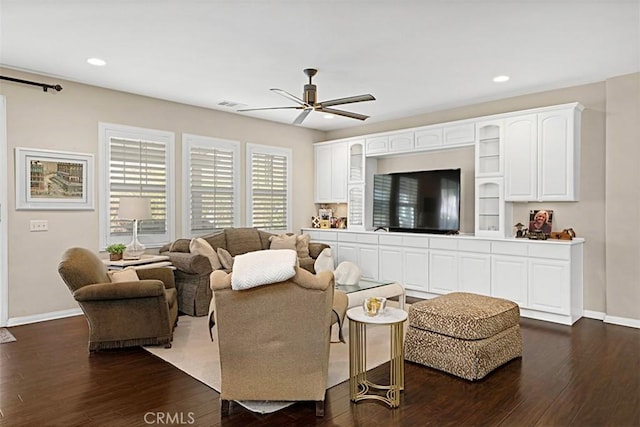 living room featuring dark hardwood / wood-style flooring and ceiling fan