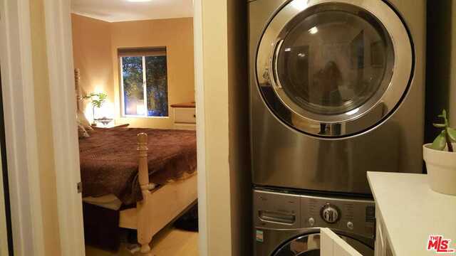 washroom with stacked washer and clothes dryer