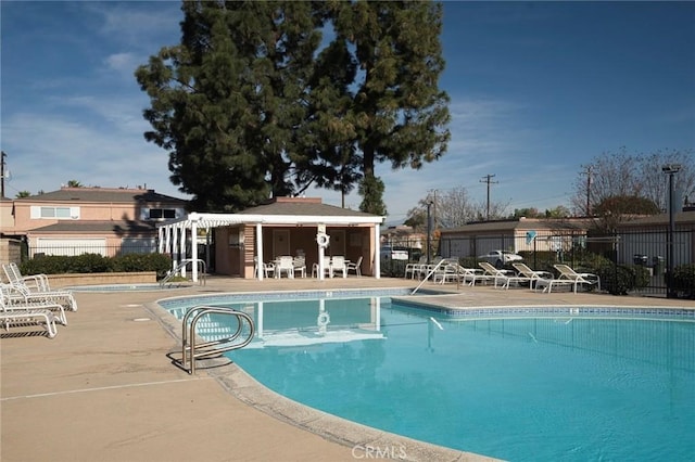 view of swimming pool featuring a pergola and a patio area