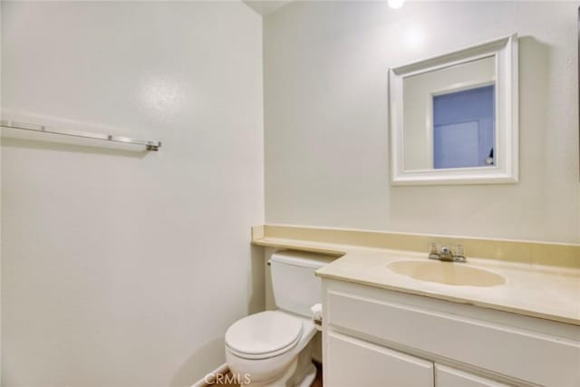 bathroom with toilet and vanity