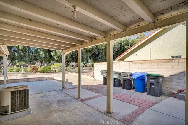 view of patio with fence and central AC unit