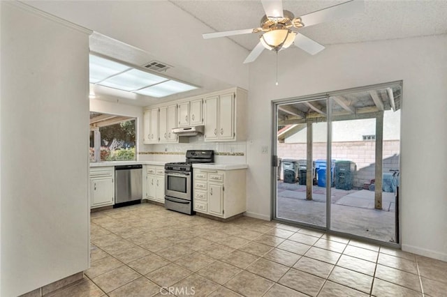 kitchen featuring light tile patterned floors, under cabinet range hood, appliances with stainless steel finishes, light countertops, and visible vents