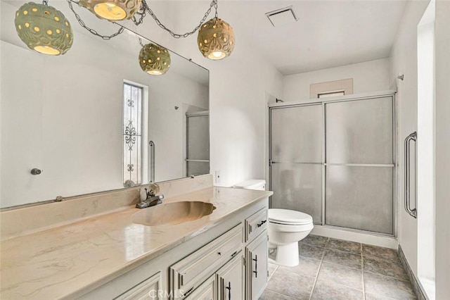 bathroom featuring toilet, an enclosed shower, and vanity