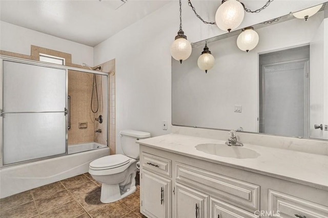 full bathroom with bath / shower combo with glass door, toilet, and vanity