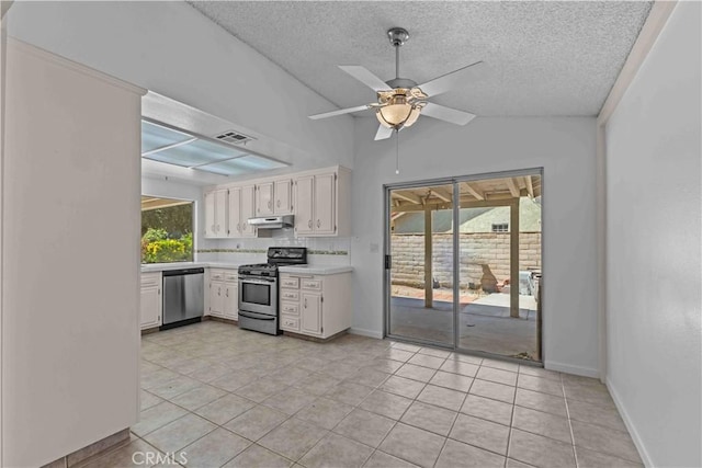 kitchen featuring a textured ceiling, ceiling fan, stainless steel appliances, light countertops, and under cabinet range hood