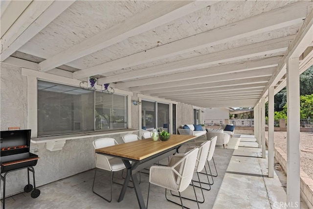 view of patio with fence and outdoor dining area