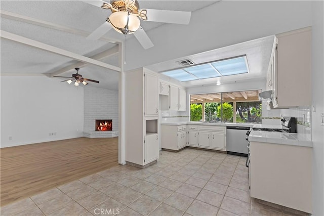 kitchen featuring light tile patterned floors, a ceiling fan, visible vents, dishwasher, and open floor plan