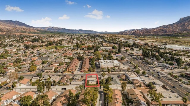 birds eye view of property with a mountain view