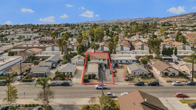 birds eye view of property with a mountain view