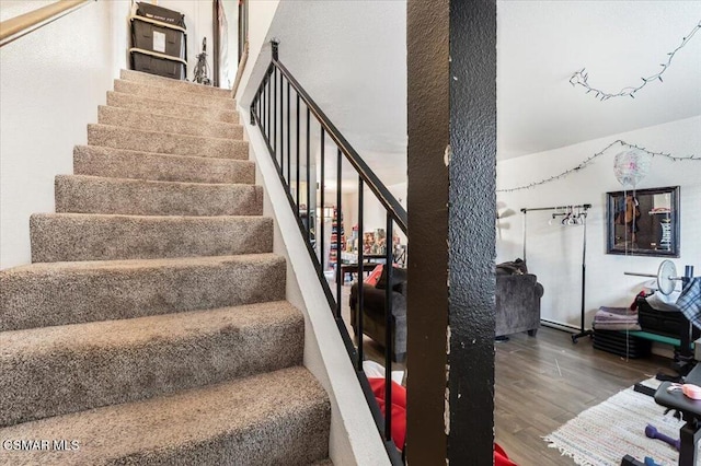 staircase with wood-type flooring