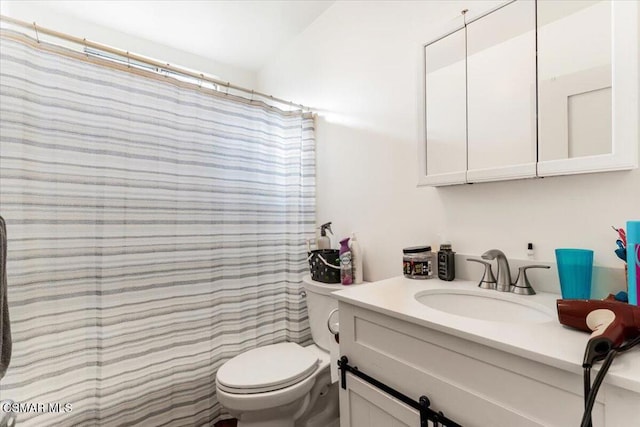 bathroom with toilet, vanity, and a shower with curtain