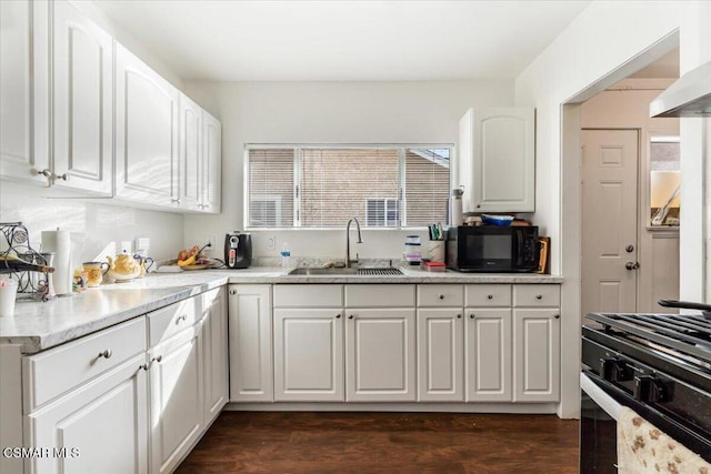 kitchen with dark wood-type flooring, white cabinetry, sink, and black appliances