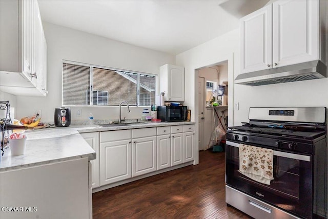 kitchen with sink, white cabinets, dark hardwood / wood-style floors, and stainless steel gas range oven