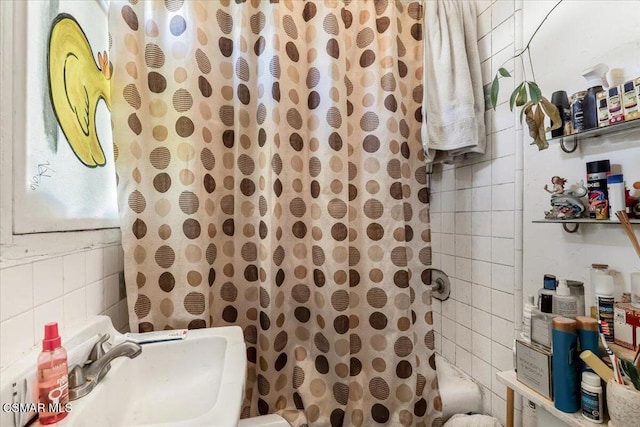 interior space with shower / bathtub combination with curtain and sink