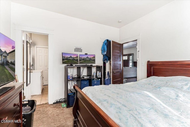 bedroom featuring light colored carpet