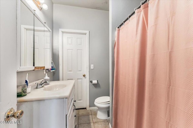 bathroom with toilet, vanity, a shower with curtain, and tile patterned flooring