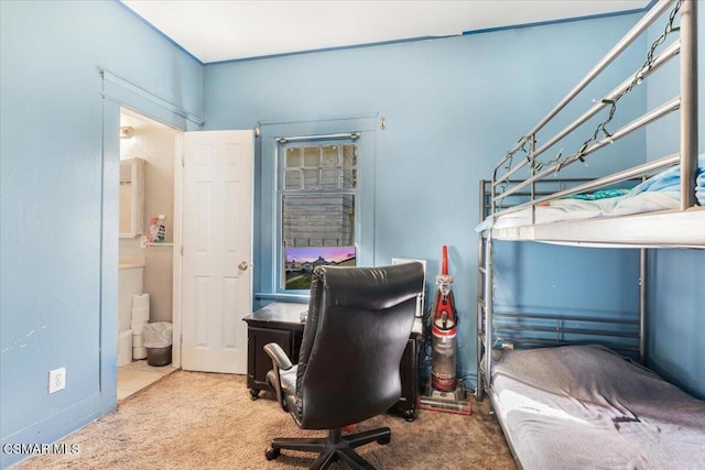 bedroom featuring connected bathroom and carpet floors